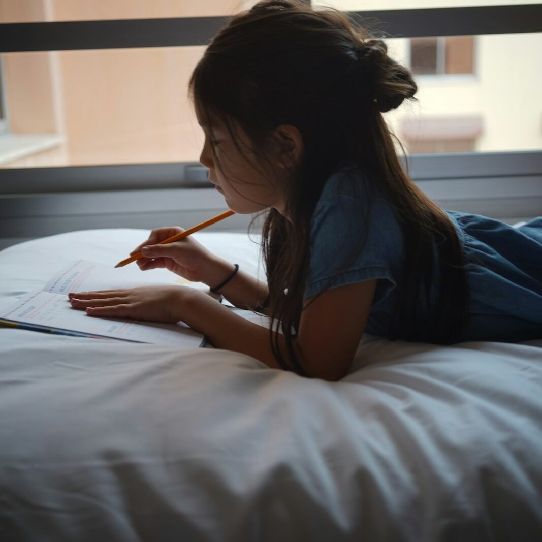 a woman writing on a book